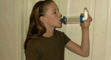 person using valved-holding chamber